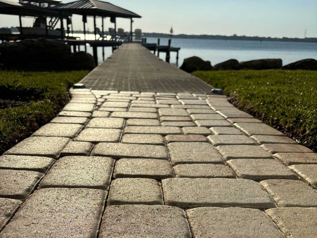 Beautifully sealed tan pavers to the river.